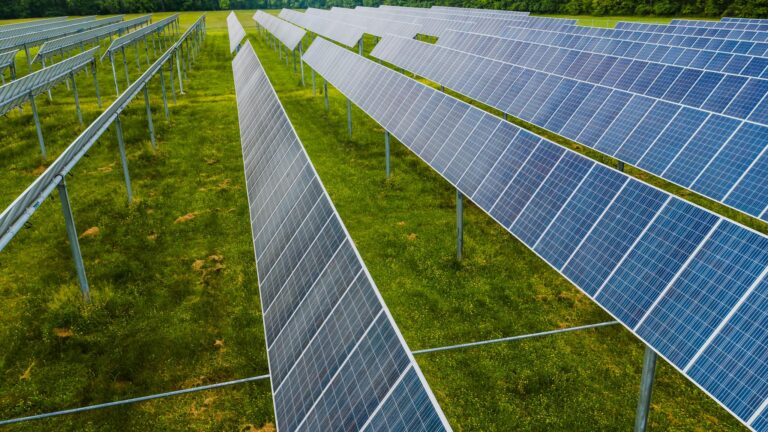 Aerial view of solar panels in a green field, Rossville, GA.