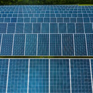 Contemporary installation of solar panels mounted on field in environmental friendly solar power station